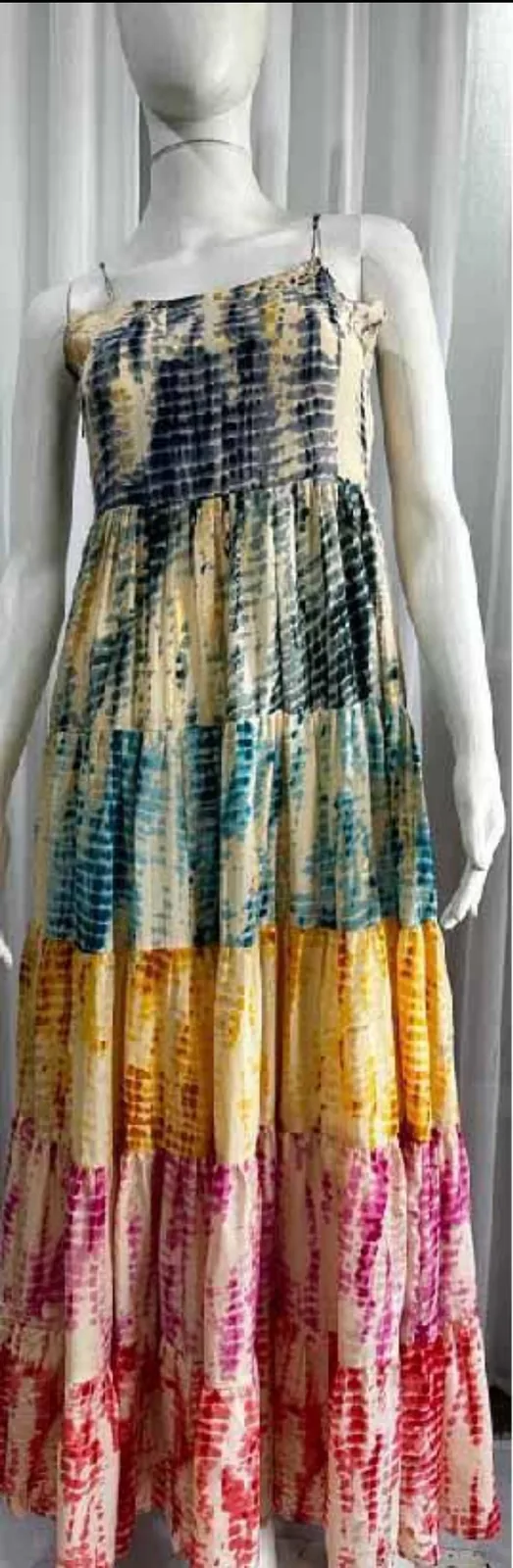 Front view of a multicolour tie-dye tiered maxi sundress on a dress form